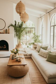 a living room filled with lots of furniture and a fire place in front of a window