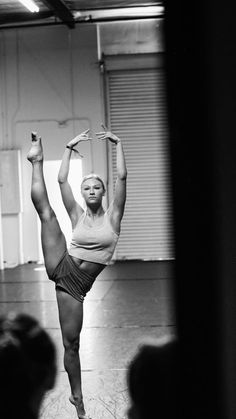 a woman is doing a handstand on the floor