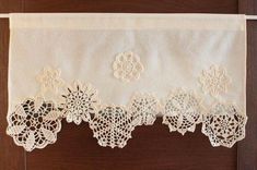 an embroidered lace curtain with flowers on it