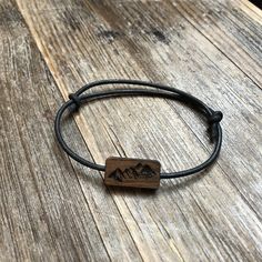 A unique, original bracelet with a wooden symbol placed on a leather strap. The bracelet is made by hand from natural materials: wood (walnut) and leather. Engraving made with laser so that you can freely personalize. The bracelet is adjustable by moving the tightened loops and can be adjusted to any wrist size. Thanks to the use of natural materials, the bracelet is not terrible water, you can not even take it off and take a bath with it. If you have not found the right graphics for you, then a Adjustable Wood Jewelry In Nature-inspired Style, Adjustable Wood Jewelry Nature-inspired, Adjustable Nature-inspired Wooden Jewelry, Adjustable Wood Bracelets As Gifts, Adjustable Wooden Bracelets As Gifts, Adjustable Laser Engraved Bracelets For Everyday Wear, Adjustable Natural Wood Bracelets, Adjustable Natural Wood Bracelet, Adjustable Black Wooden Jewelry