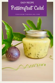 a jar of passion fruit curd next to a figurine on a table