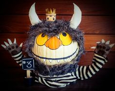 a stuffed animal wearing a crown and striped shirt