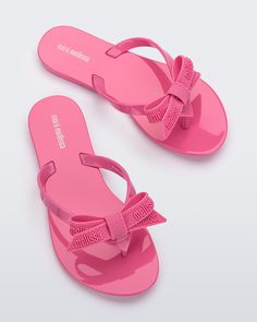 Step into summer with Mini Melissa Harmonic M Lover flip flops. The delicate bow, adorned with the iconic Melissa logo adds a romantic touch to this timeless silhouette. These are ultra-lightweight and practical, making them the perfect choice for every warm-weather outfit. Plus, you can match your mini! Casual Summer Sandals With Bow, Casual Bow Sandals For Summer, Chic Pink Flip Flops For Summer, Adjustable Bow Sandals For Beach, Summer Bow Sandals For Beach, Casual Summer Flip Flops With Bow, Pink Flat Sandals With Bow, Summer Bow Flip Flops With Open Toe, Trendy Beach Sandals With Bow