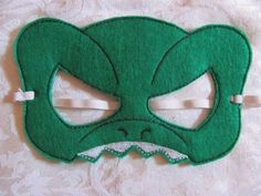 a green mask with an angry face on it