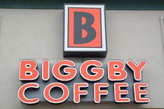 the biggby coffee sign is on the side of the building