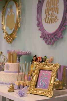 a table topped with lots of cake and decorations