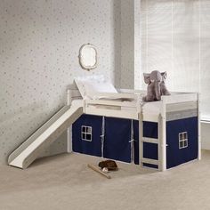 a child's loft bed with a slide in the middle and a blue house on top