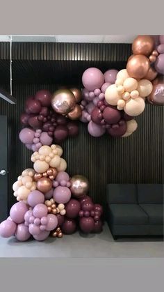 balloons are arranged in the shape of a pyramid on top of a couch and table