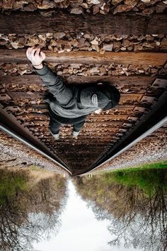 a man is jumping in the air on a bridge