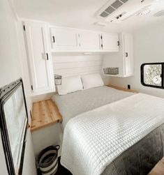 a bed sitting inside of a bedroom next to a window