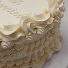 a close up of a cake with white frosting