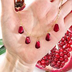 Persephone Necklace, Greek Mythology Jewellery, Pomegranate Charm Necklace, Pomegranate Jewellery,  Pomegranate Seed Charm The sheer beauty of this spectacular pomegranate necklace is so eye catching.  5 realistic juicy red pomegranate seeds made from resin with gold plated loops hang from a hypoallergenic stainless steel gold plated chain. The pomegranate seeds are so ripe and juicy looking, you will not believe how real these look. A gorgeous necklace for Summertime and all year round. The pomegranate is an ancient fruit and has a special meaning in many cultures and religions. It symbolize love, life and strength. The special symbolism, combined with its attractive and interesting shape, makes pomegranate jewelry an interesting choice. The sheer beauty of this pomegranate necklace is th Greek Mythology Hades, Persephone Necklace, Red Garnet Jewelry, Hades Persephone, Greek Mythology Jewelry, Pomegranate Necklace, Pomegranate Earrings, Mythology Jewelry, Pomegranate Jewelry