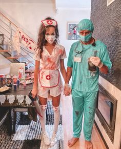 a man and woman dressed up as nurses walking down the hall together in scrubs