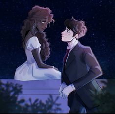 a man and woman standing next to each other in front of the sky at night