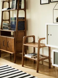 a book shelf with books on it next to a chair