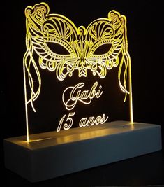 an illuminated sign with the name and image of a mask on it's face