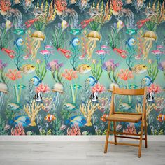 an underwater scene with fish and corals wallpaper mural in a living room setting