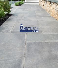 a stone walkway with steps leading to the front door