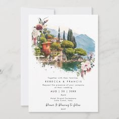 save the date card with watercolor painting and flowers on it, sitting on a marble surface