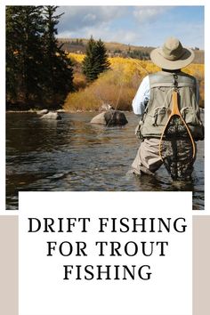 a man standing in the water while holding a fishing rod and wearing a hat with his back turned to the camera