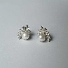 DESCRIPTION: These dainty pearl and flower style stud earrings by Pearl Sand Pretties combine elegance with a playful touch. Perfect for everyday wear, they make a thoughtful birthday gift for your wife or any special woman in your life. BEST FEATURES: Unique combination of pearls and flower motifs for a playful yet elegant look. Perfectly sized for everyday wear, adding a subtle touch of elegance to any outfit. Made with genuine pearls for a beautiful luster and durability. Suitable for various Flower Shaped Pearl Earrings For Anniversary, Flower Pearl Drop Earrings For Anniversary, Pearl White Flower Pearl Earrings For Anniversary, Flower-shaped Pearl Earrings For Anniversary, Silver Flower Pearl Earrings For Anniversary, Pearl Flower Earrings For Anniversary, Anniversary Pearl White Flower Earrings For Pierced Ears, Silver Flower Shape Pearl Earrings For Wedding, Flower Motifs