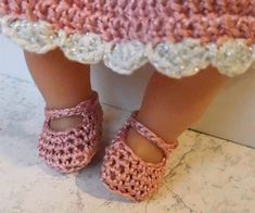 a close up of a child's feet wearing crocheted shoes