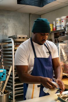 a man in an apron is preparing food