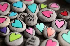 some rocks with hearts and words painted on them