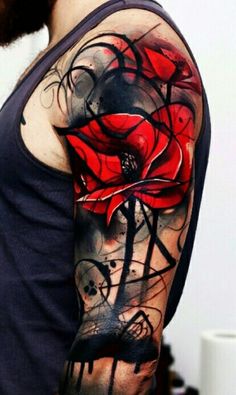 a man's half sleeve with red flowers and black ink on his left arm