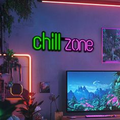 a computer desk with a monitor and keyboard on it in front of a neon sign that reads chill zone