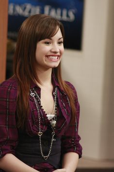 a woman standing in an office smiling for the camera