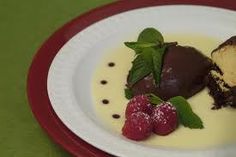 a white plate topped with three desserts on top of a red and green table