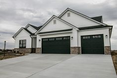 a large white house with two garage doors