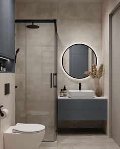 a white toilet sitting next to a walk in shower under a round mirror above a sink