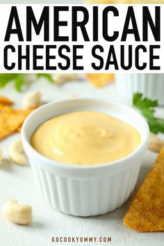 American homemade cheese sauce in a white ceramic bowl near nuts and nachos on a white table. American Cheese Dip, American Cheese Recipes, Nachos Fries, Easy Nacho Cheese, Simple Cheese Sauce, Velveeta Cheese Sauce, Melted Cheese Sauce, Easy Cheese Dip