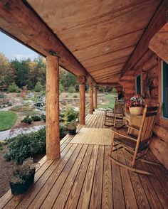 a wooden porch with rocking chairs on it