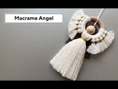 an ornament with tassels hanging from it's side and the words macrame angel above it