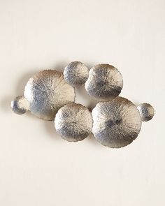 four silver balls are sitting on a white surface