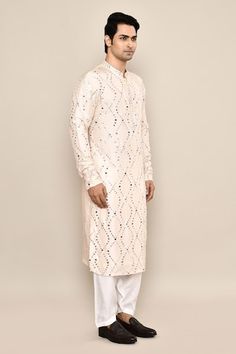 Blush cream kurta featuring mirror embroidery in the front and sleeves. Paired with a white salwar. - Aza Fashions Off White Kurta With Mirror Work For Festivals, Festive Off White Kurta With Mirror Work, Off White Kurta With Mirror Work For Eid, Off White Mirror Work Kurta For Eid, Festive Off-white Kurta With Mirror Work, Cream Kurta With Mirror Work For Diwali, Festive Cream Kurta With Mirror Work, Salwar Pattern, Embroidered Silk