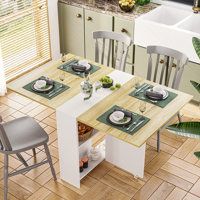 a kitchen table with chairs and plates on it