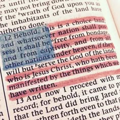 an open bible with the american flag painted on it's side and words written in red, white and blue