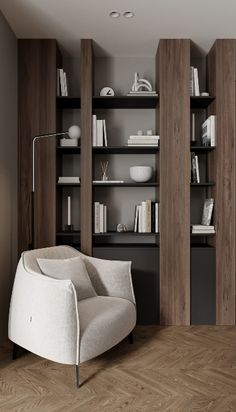 a white chair sitting in front of a book shelf