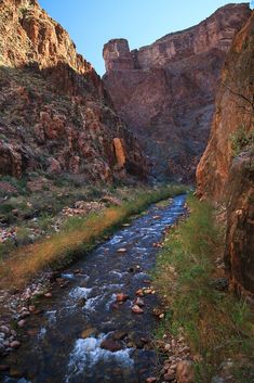 a river running through a canyon surrounded by mountains