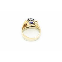 Very cool modernist stylized ring featuring a prong set oval tanzanite  (approximately 1.65 carats) which is accented by a single .15 carat (approximate weight) carat round full cut diamond and an additional 19 bead set diamonds.  The approximate total diamond weight for the piece is .50 carats.  The shank is yellow and white 14k gold.  there looks like there were hallmarks, but they have faded. Ring is is 7.25 US . Modern Tanzanite Gemstone Ring, Modern Tanzanite Rings, Modern Oval Tanzanite Sapphire Ring, Modern Sapphire Ring Oval Cabochon For Formal Occasions, Oval Tanzanite Ring For Formal Occasions, Modern Oval Tanzanite Ring, Formal Oval Tanzanite Ring, Formal Oval Tanzanite Birthstone Ring, Oval Tanzanite Birthstone Ring With Accent Stones