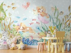 there is a wall mural in the children's room with mermaids and fish