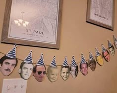 a group of people wearing party hats hanging on a wall