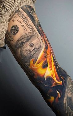 a man's arm with money and flames on it