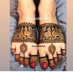 two feet with henna tattoos on them