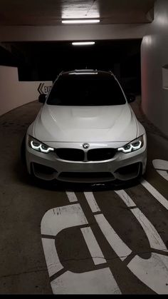 a white car parked in a parking garage