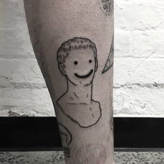 a man's leg with a drawing of himself on it